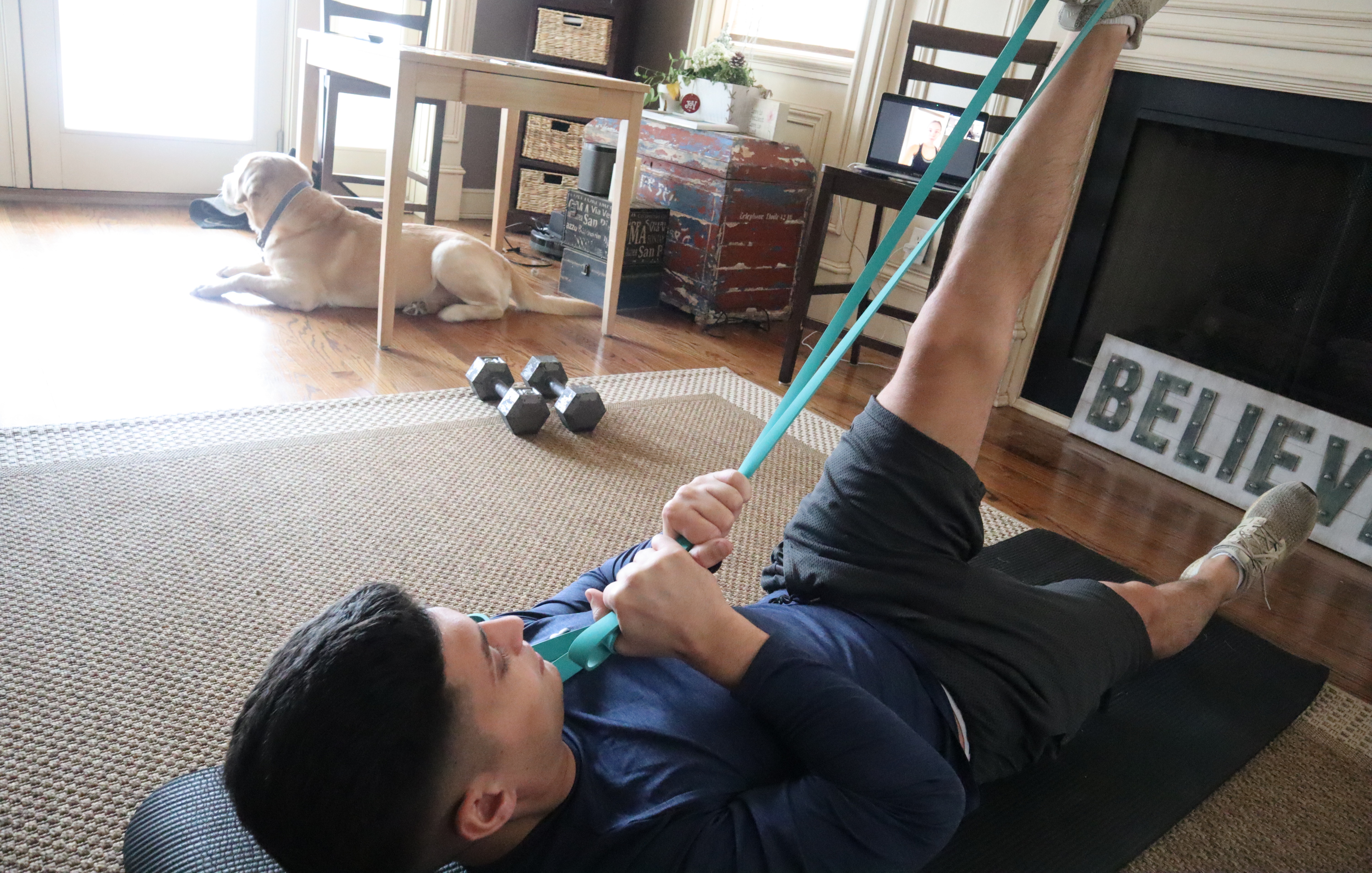 Photo of customer performing hamstring stretch at home